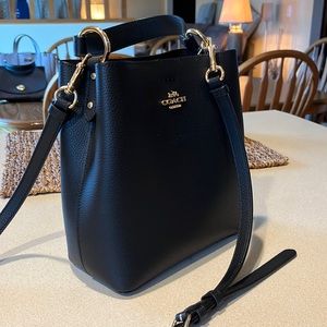 Brand: Coach. Color: Black. Size: 8" (L) x 8 1/2" (H) x 4" (W)